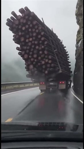Logging Truck Tips Over on Mountain Curve, Sending Half Its Load Over the Cliff (Video By AI )