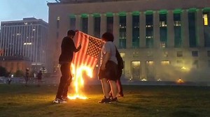 Protesters burn a flag in front of Nashville's Metro Courthouse. | Tennessean