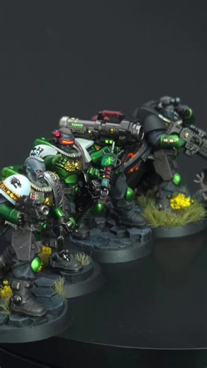 Salamander Scout Squad is here in full! The miniatures are from the Scout Squad killteam box. 4 of the 5 bases feature basalt rocks and columns bits from @Make It Epic The tufts of grass are from the highland grass set from @gamersgrass . The Warrior carries a variety of grenades like Frag, Krak, and Incendiary. The Heavy Gunner has a Missile Launcher and also has a variety of payload options on his belt. The Sniper has an active camo cloak that blends him into his environment so he can conceal 