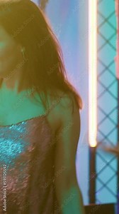 Vertical video: Cheerful adults enjoying dance party, having fun together with breakdance battle on dance floor. Young people showing off cool dance moves on electronic music, clubbing. Handheld shot. Stock Video