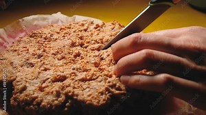 girl cuts off a piece of cake and takes it out, close-up