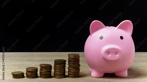 Time lapse, Stop motion 4K. Save money and account banking for finance concept, Hand with coin and piggy bank on blurred background