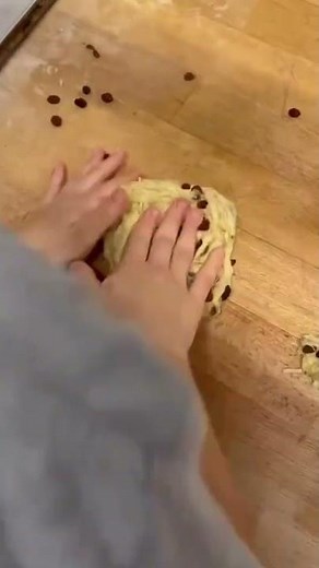 the process of making choco chip bread, where the dough is weighed to the same weight and then baked