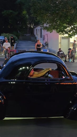 Blown 1941 Willys hot rod cruises by slow in Lake George Village New York during the 2025 Adirondack Nationals car show week | Samspace81