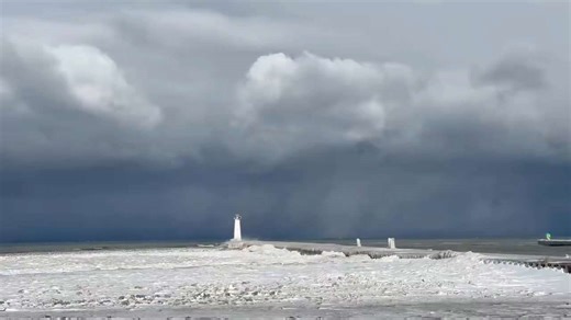 Storm clouds loom over historic Sodus Point Lighthouse as winter weather hits New York