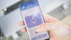 Using an online appointment app to schedule a rendezvous to the dentist on a smartphone screen.