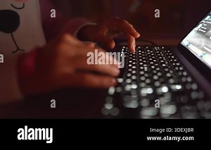 hands practicing typing on illuminated laptop keys, deliberate slow keystrokes and learning atmosphere in soft evening light Stock Video Footage - Alamy