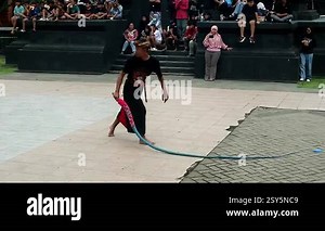 a group of traditional Javanese dancers dancing in sunglasses and orange costumes with their friends at night