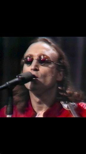 FlamingBeatles on Instagram: "On April 18th, 1975, John Lennon gave what many consider a bizarre appearance on Salute to Sir Lew, a TV special honoring British media tycoon Lew Grade. Wearing a red leather jumpsuit and backed by bald men in black leather with fake faces on the back of their heads, Lennon performed “Slippin’ and Slidin’,” “Stand By Me,” and “Imagine.” Of these, only “Stand By Me” has never been officially released, with just short snippets surfacing online in recent years. This w