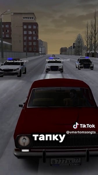 1970s Vintage Car Driving Through Snowy Urban Streets