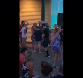 old man dancing at outdoor concert has fedora and weird dance moves