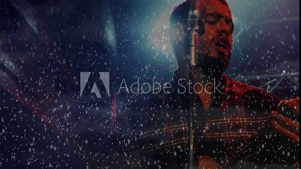 Performer singing, strumming guitar, activating snow and lightning graphics during music show