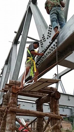 Construction Workers Enhancing Steel Bridge Structure