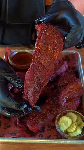 Country-style pork loin ribs are slow-smoked at 225°F on an Oklahoma Joe’s reverse flow smoker using lump charcoal and apple wood, which creates a clean, subtly sweet smoke and a robust bark. The dry-rubbed ribs are finished with a rich braise in butter, brown sugar, and a house-made vinegar-based BBQ sauce. The result is tender, succulent pork with a perfect balance of sweetness, heat, smoke, and Texas character, offering a desirable