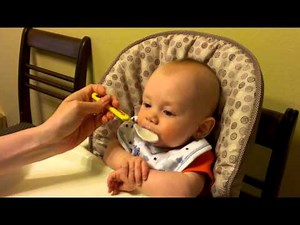 Cute baby eating rice cereal.