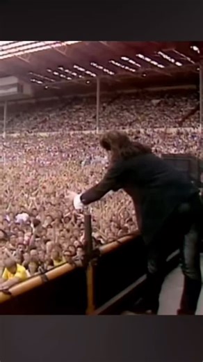 U2 Breathe on Instagram: "🎶 40 years of Live Aid! Gavin Edwards: Bono drops the microphone with a loud clunk. He roams the stage, trying to exhort the crowd, feeling that something in the band’s performance is lacking. Searching for it, he jumps down onto the stage’s apron: a narrow platform in front of the main stage and its monitors, about two feet lower. He runs the length of the apron, towards something on stage right: disappointingly, it’s a cadre of photographers. I don’t like the distanc