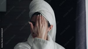 young woman takes care of her facial skin. Doing beauty treatments. Rubbing cream into the skin of the face. Morning Routine. Beauty, Pampering, Home Spa Concept. Skin Care Cosmetic Concept