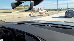 Driver passes by plane that landed on HWY 407