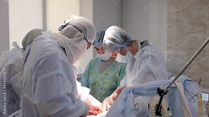 A team of surgeons working together in a modern operating room during a complex procedure. The photo highlights the advanced medical equipment and the focused collaboration of the surgical team