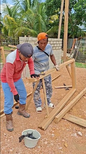 A senior carpenter shows how to properly nail a door frame.