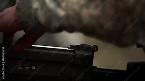 Close-up of a soldier loading a machine gun. Stock Video