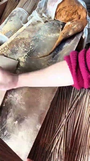 Hand pressing flat tool over powdery crafting surface