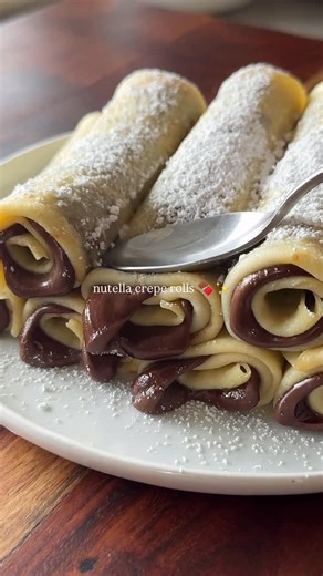 a flavorful bite • food & recipes on Instagram: "nutella crepe rolls 🍫✨ - homemade crepes rolled and stuffed with nutella 🔗 full recipe is on my website link in bio ✨ #nutella #crepes #easyrecipes #comfortfood"