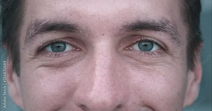 Close-up happy and satisfied eyes of man who smiles at camera. Sincere, wide smile lights up face, squinting his eyes and emphasizing fine lines. Smile and look radiate kindness and love for people.