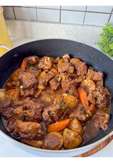 SUNDAY BEEF STEW * Beef, cut into chunks, black pepper, Rajah curry powder, seven colours spice mix, Paprika, Cooking oil, onions, Beef stock, Potatoes, Carrots, (or any vegetables of your choice), and Green onions. 1. Place the beef in a bowl and add black pepper, rajah, seven colours, and paprika. 2. Mix well until the meat is evenly coated with the spices. 3. Heat oil in a large pan or pot. 4. Add the chopped onions and cook until soft and fragrant. 5. Add the seasoned beef to the pan. 6. Sti