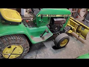 Installing snow chains on John Deere 212 riding lawn mower.