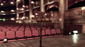 Old opera house stage with a music stand set for a captivating performance