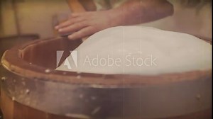 A man makes the traditionally Italian cheese. Video with vintage effect