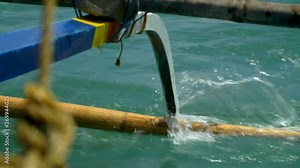Close up on the side of a bangka boat skidding across the ocean surface in slow motion, Caramoan Islands Philippines