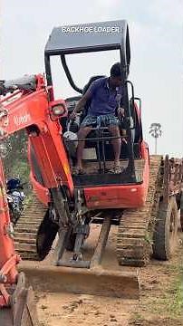 Mini Excavator Kubota loading a tractor
