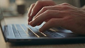 Man hands typing laptop keyboard searching internet in office desk close up. Unknown businessman writing business email message at computer. Male programmer creating code working at corporate table.