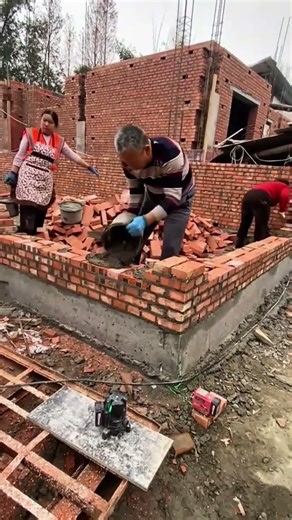 building a sturdy brick wall on a new construction site using mortar and professional masonry tools