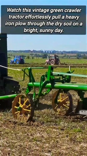 Old Fashioned Tracked Tractor Pulling Heavy Iron Plow Equipment