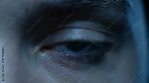Man eye close up with red laser light scanning, futuristic technology for retina verification or data interface. Biometric security footage.