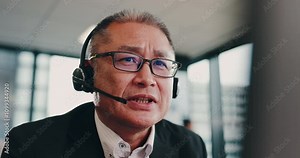 Call center, mature man and Japanese agency for customer service, technical support and consulting. Male person, talking and telemarketing for advice, conversation and feedback as help desk operator