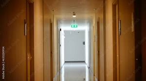 inside the apartment building has signs and fire escape doors in the building, Fire escape in a high rise building, Flashing emergency lights