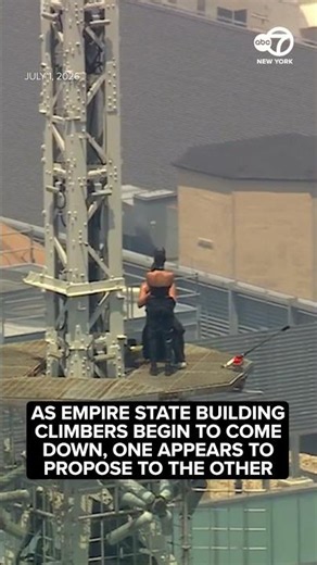 2 people climb to top of Empire State Building with pro-peace banner