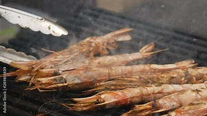 Fresh langoustines are cooked on the grill or barbecue in the fresh air. Street food. fried langoustine