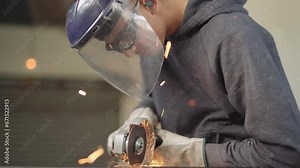Skilled Worker Using a Grinder for Metal Cutting in Dynamic Poses and Angles, Ready for Action in the Advanced Metallurgical Industry in 4K Quality