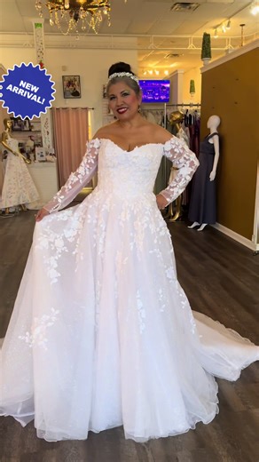 Brides, this beauty by @DEMETRIOSBRIDE▪️Wedding Dress just arrived! Made to move, to glow, and to turn every head. Style 1502 features an off-the-shoulder neckline with dimensional lace sleeves, a shimmering tulle skirt, and sheer back details that reveal a whisper of skin beneath delicate floral appliqués. Are you ready to shop for your dream dress? Give us a call at 210-967-4696 or request an appointment on our website. #fyp #longsleeveweddingdress #uniqueweddingdress