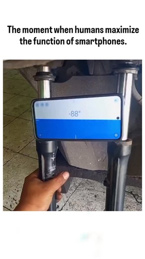 HISTORY INFO | WEALTH on Instagram: "The video depicts a motorcycle rider in Indonesia mounting a smartphone between the front forks as an improvised license plate, with the screen displaying animated numbers like -88 or -90 to simulate a real plate number. Posted by @leyaclista , an account curating viral quirky hacks, the clip amassed 768,000 views and 1,400 likes within hours, drawing lighthearted Indonesian replies praising the ingenuity. This absurd "maximization" of smartphone use highligh