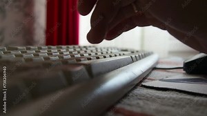 Woman hand quickly types text on keyboard at home. Work from home. Freelancer works remotely. Keyboard on the table, red curtain by the window. Keyboard typing. Fine hand motor skills. ASMR with keys. Stock Video