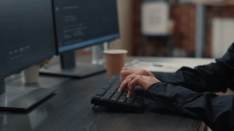 clip-3999996777-close-developer-hands-typing-programming-code-while