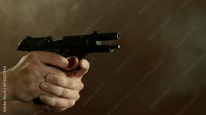 Man Shooting a Pistol on Dark Background . Super Slow Motion Filmed on High Speed Cinematic Camera at 1000 fps