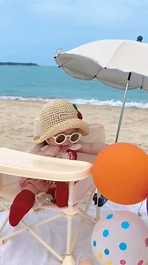 Beach Day Bliss in Sanya! 🌊👶 This little cutie is living the dream: chilling in a cherry hat, cool shades, and surrounded by colorful balloons! Pure sunshine vibes on Sanya’s beach. ☀️🎈 #SanyaBeach #BabyAdventures #SummerVibes | Go Sanya