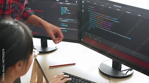 Slow motion back end or software developer manager supervising his team on new application program development on debugging and solving complex code algorithms on monitor. Burgeoning